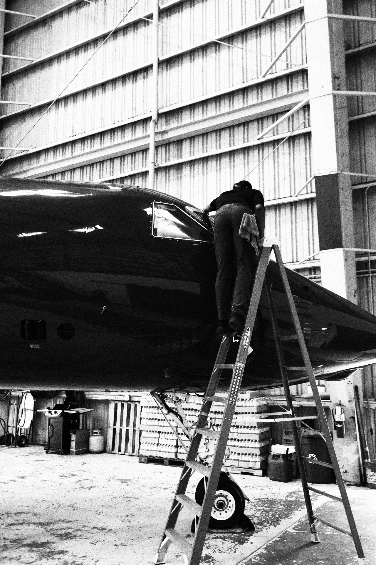 Technician hand-wiping aircraft fuselage