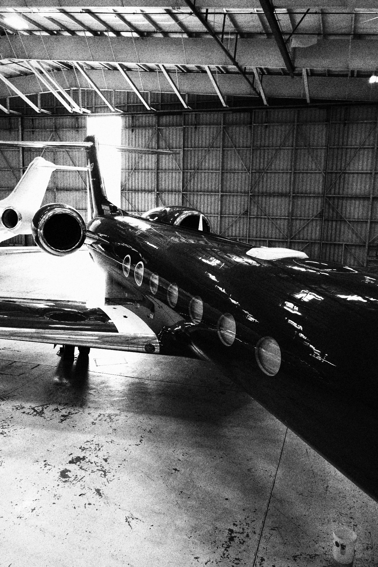 Private jet parked inside hangar